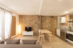 a kitchen and a living room with a table in a room at Lets Holidays apartment Sant Miquel in Tossa de Mar