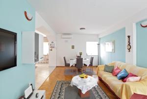 a living room with a couch and a table at Stone Villa Rea in Mravince