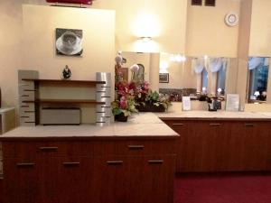 a kitchen with a counter with flowers on it at Dom Gościnny Emilia in Pobierowo +24 photos
