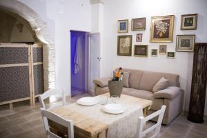 a living room with a table and a couch at Al Caveau - Holiday House in Fasano