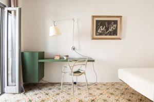 a desk in a bedroom with a bed and a chair at Dimora Talenti in Polignano a Mare