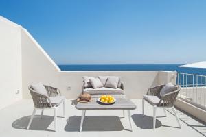 a balcony with a table and chairs and a couch at Dimora Talenti in Polignano a Mare