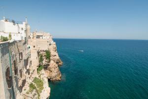 an aerial view of the ocean next to a cliff at Dimora Talenti in Polignano a Mare