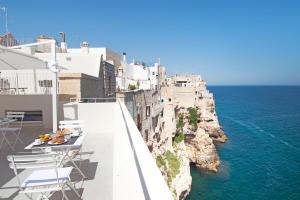 a balcony with chairs and a view of the ocean at Dimora Talenti in Polignano a Mare