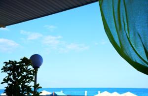 a view of the ocean from a window with a plant at Hotel Palma in Odesa