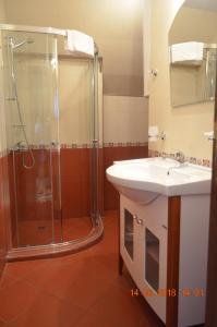 a bathroom with a sink and a shower at Guesthouse Opal in Ravda +30 photos
