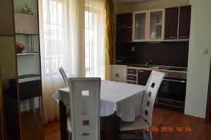 a kitchen with a table and chairs in a room at Guesthouse Opal in Ravda