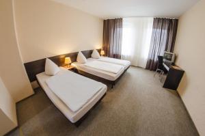 מיטה או מיטות בחדר ב-Hotel-Pension Victoria