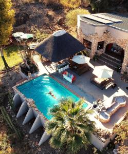 an overhead view of a swimming pool with an umbrella at Sasa Safari Camp & Tours in Outjo