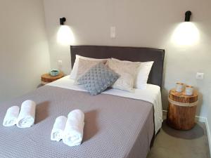 a bedroom with a bed with white towels on it at Vathy Studios in Meganisi