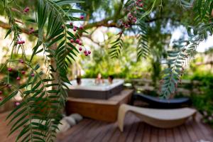 a bath tub in a garden with a tree at Hotel Corallo in Pomonte