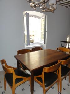 a dining room with a wooden table and chairs at La Maison des Augustines in Marseille