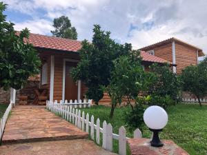 a house with a white picket fence in front of it at The Mussel House in Ksamil
