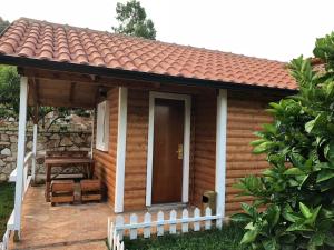 a small wooden cabin with a white fence at The Mussel House in Ksamil +37 photos
