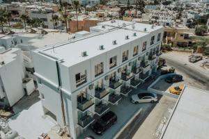 an aerial view of a white building with a parking lot at River View Boutique Apts in Ayia Napa
