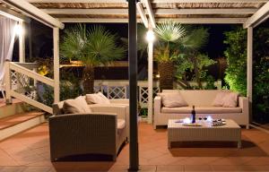 a patio with two couches and a table at Hotel Corallo in Pomonte