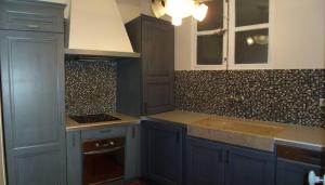 a kitchen with blue cabinets and a sink at La MAISON du PORT in Marseille