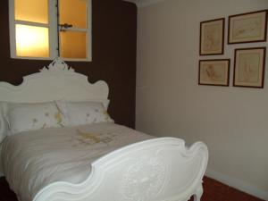 a bedroom with a white bed with a white headboard at La MAISON du PORT in Marseille