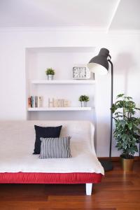 a bedroom with a bed and a lamp and a plant at Cosy Luxury Apartment - Lisbon Center in Lisbon