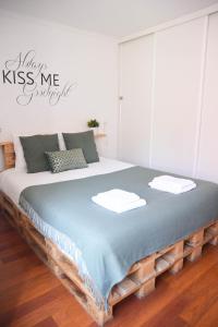 a large bed in a room with a sign on the wall at Cosy Luxury Apartment - Lisbon Center in Lisbon