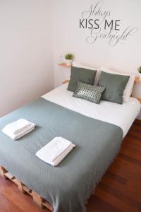 a large bed with two towels on top of it at Cosy Luxury Apartment - Lisbon Center in Lisbon