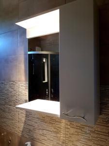 a bathroom with a mirror and a sink at Busas Apartment in Tbilisi City +22 photos