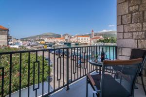 a balcony with a table and a view of a city at 4 Elements Old Town Views Rooms in Trogir