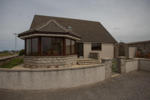 a small house with a roof on a wall at Golfview in Buckie