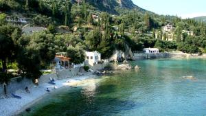 a group of people on a beach next to a river at Sea Breeze in Paleokastritsa