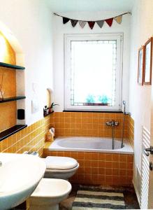 a bathroom with a tub and a toilet and a sink at L'Antico Frantoio in Rapallo