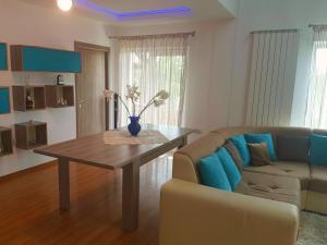 a living room with a table and a couch at Nobless Villa in Mereni