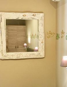 a mirror hanging on a wall in a room at Venus Beach Hotel in Nea Stira