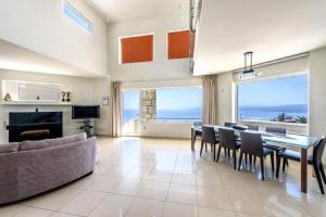 a large living room with a table and chairs at Endless View Villa Palaiokastro in Palaiokastro