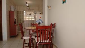 a kitchen with a table and chairs in a room at Residencia Pereira in Serra Negra