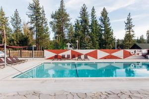 a swimming pool with trees in the background at Noon Lodge in Big Bear Lake +74 photos
