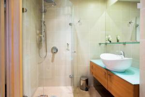 a bathroom with a sink and a shower at Old Riga Modern Apartment in Riga +28 photos