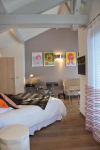a bedroom with a large bed and a living room at Le Clos Du Lac - location de chambres in Veyrier-du-Lac