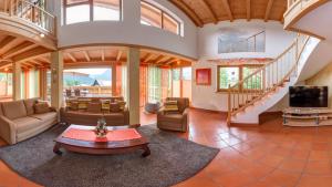 a large living room with a couch and a tv at Landvilla Romantika in Lermoos