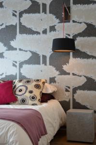 a bedroom with a military themed wall with a bed at Le Clos Du Lac - location de chambres in Veyrier-du-Lac