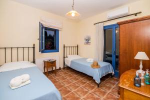 A bed or beds in a room at Leventis Villas Complex with Sharing Pool