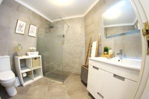 a bathroom with a shower and a sink and a toilet at Ferragudo'Spot in Ferragudo +19 photos