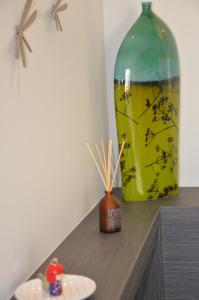 a large green vase sitting on top of a table at Le Clos Du Lac - location de chambres in Veyrier-du-Lac
