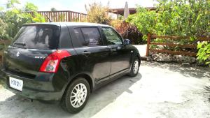 a small black car parked in a driveway at The Pool House in Saint Philip