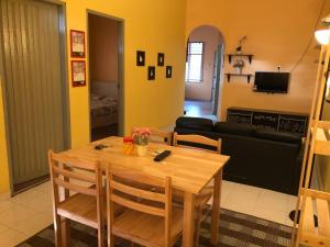 a living room with a wooden table and chairs at Addin Homestay Tanah Merah in Tanah Merah