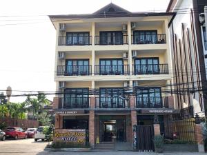 
a large building with a large window on the side of the building at Riverside House Hotel SHA Extra Plus in Chiang Mai
