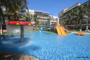 a water park with a slide and slides at Beach Living Apartamento in Aquiraz