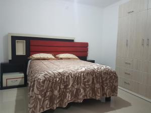 a bedroom with a large bed and a dresser at Nino´s Residence Departamentos VIP Amoblados in Tacna