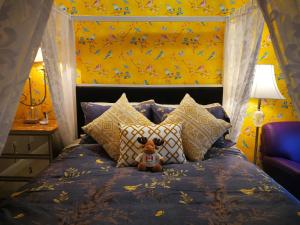 a teddy bear sitting on a bed with pillows at Lakeview Oasis Bed and Breakfast in West Kelowna
