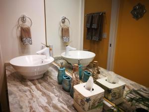 a bathroom with two sinks on a marble counter at Lakeview Oasis Bed and Breakfast in West Kelowna +48 photos