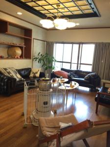 a living room with a couch and a table at Nozawa Dream in Nozawa Onsen